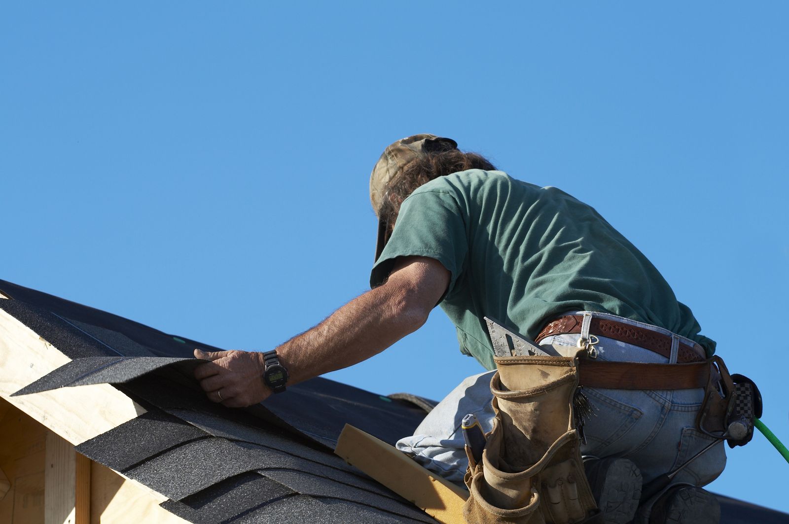Prairie Fox Roofing crew member fastening shingles on a pitched roof in Elmhurst