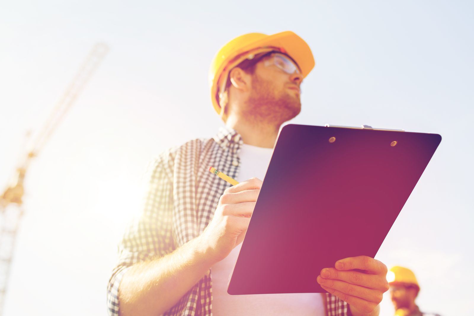 Estimator with a clipboard at a job site